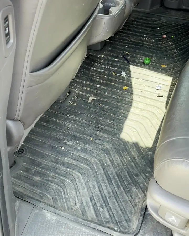 Honda Odyssey second row floor covered in crumbs, before