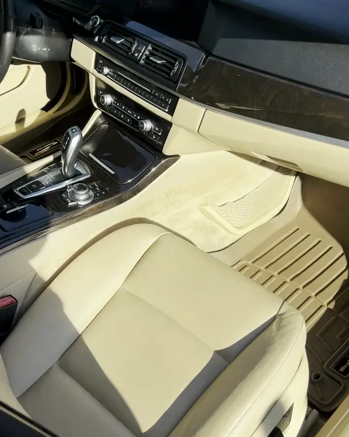 The same BMW cream carpet, clean, after