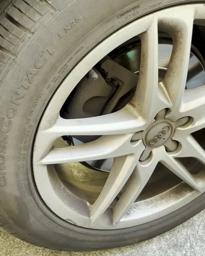 Audi wheel coated in brake dust, before